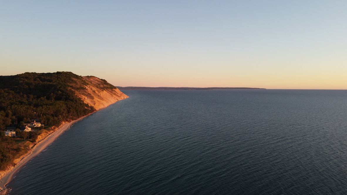 Golden hour over the Sleeping Bear Dunes coastline from above