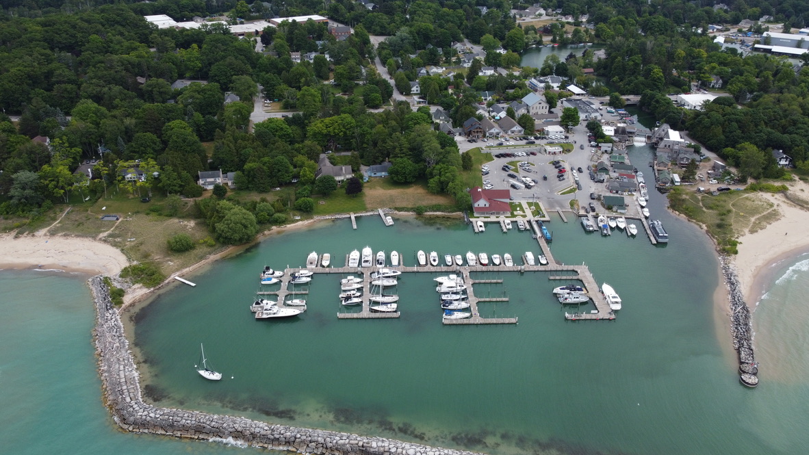 Aerial view of Fishtown harbor in Leland with boats and turquoise water