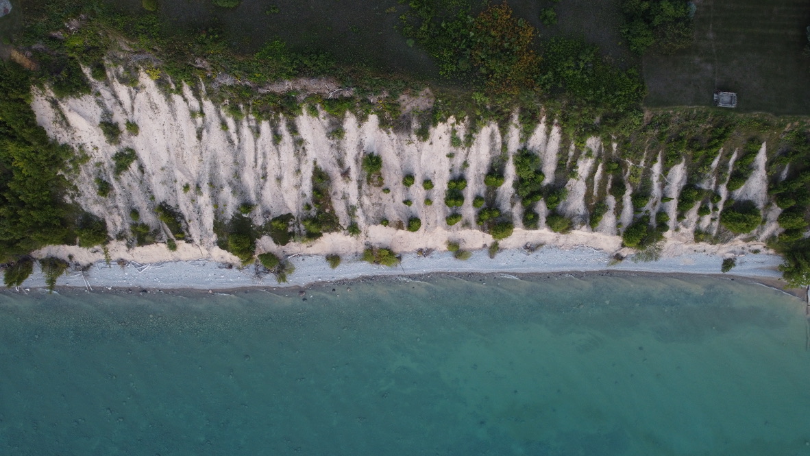 Dramatic white clay bluffs meeting crystal-clear turquoise water along the Leelanau Peninsula