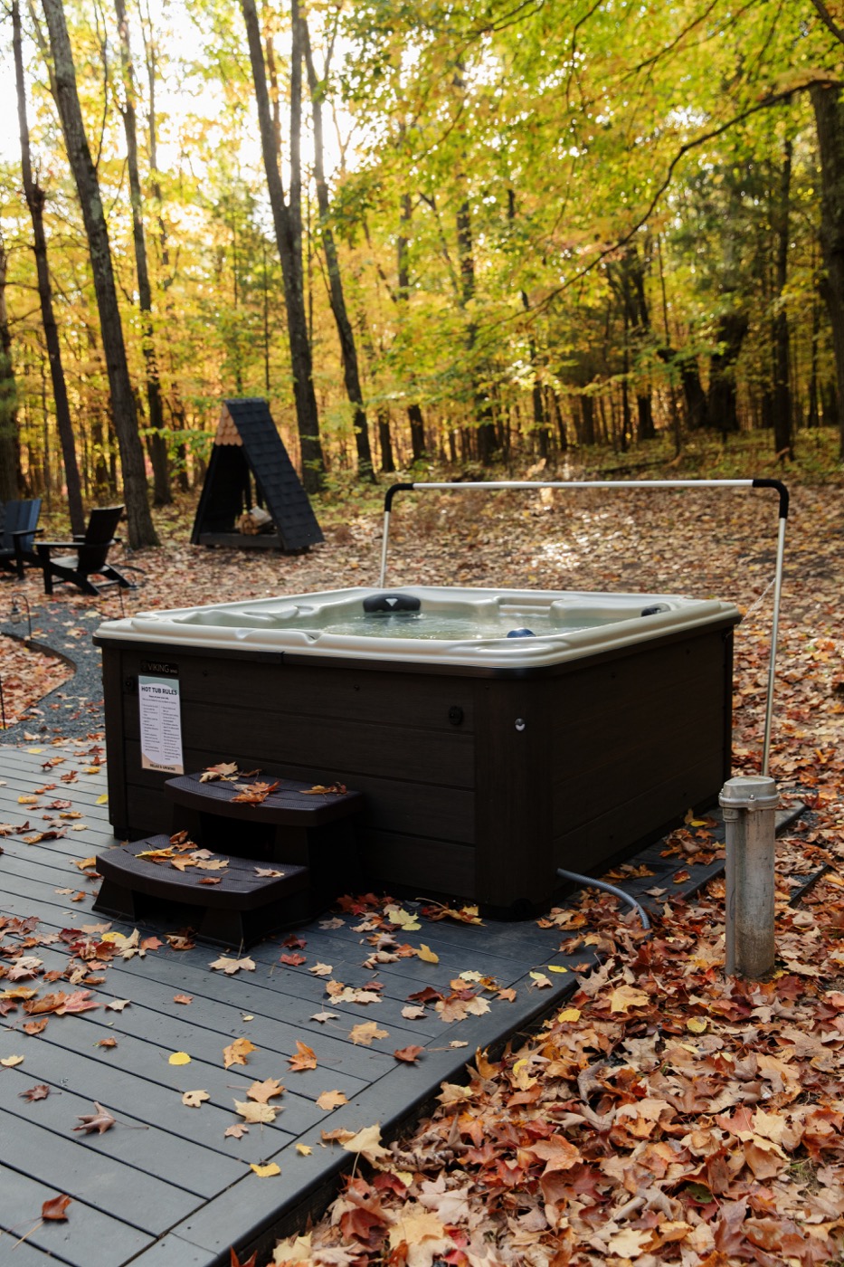 Hot tub on the deck of the Roost A-Frame surrounded by fall foliage