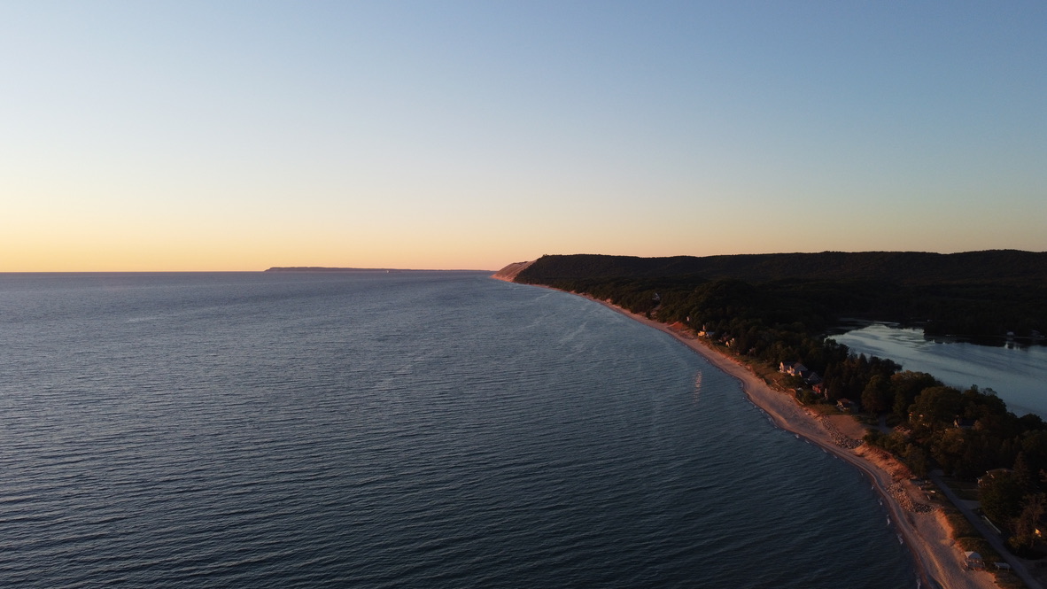 Aerial view of Empire Beach and the Sleeping Bear Dunes coastline at golden hour